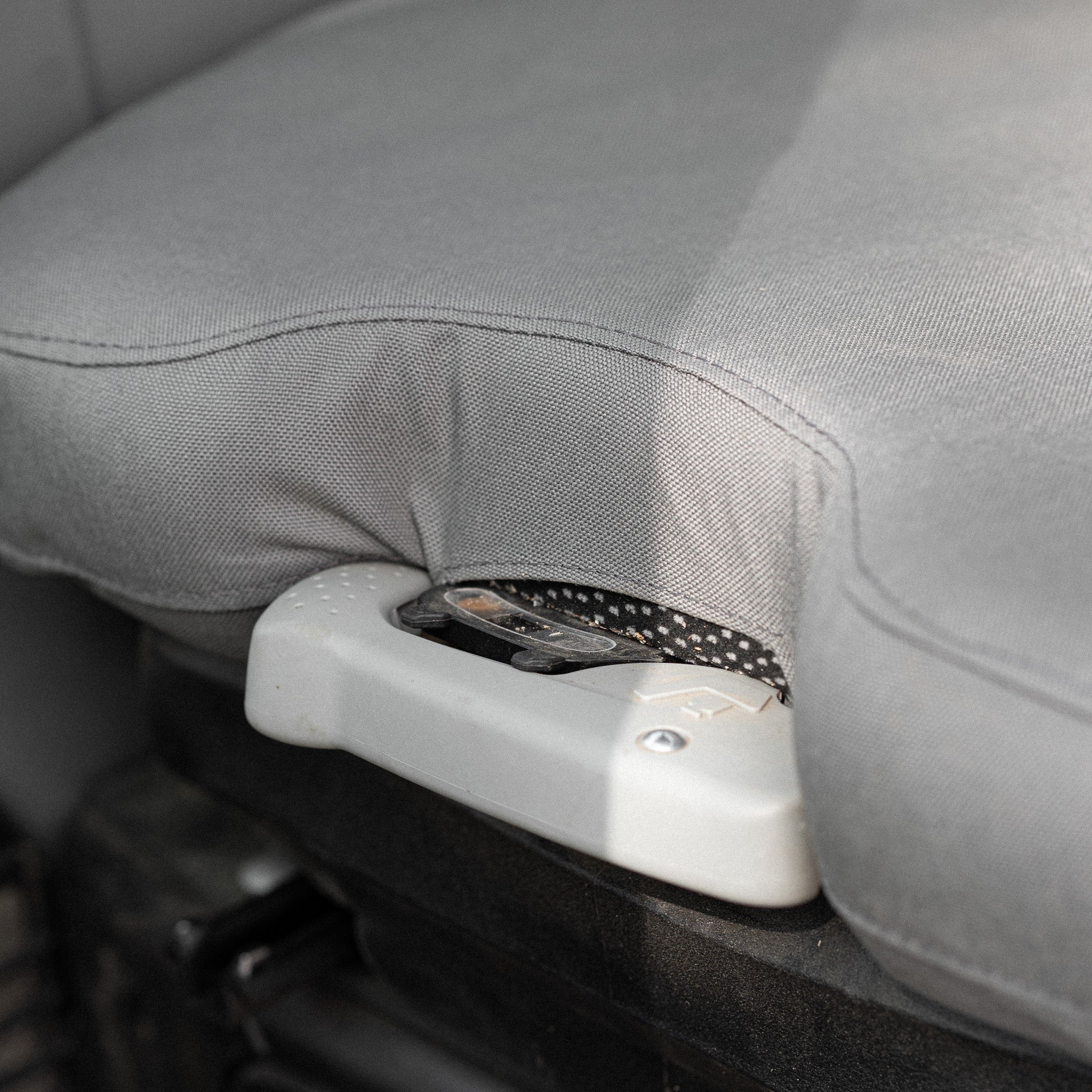 This picture shows how the seat cover fits around the adjustment handle at the front of the seat.
