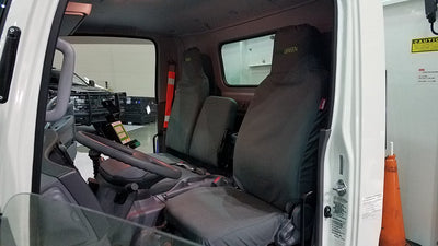 Isuzu NPR with gray Ironweave TigerTough seat covers and custom embroidery.