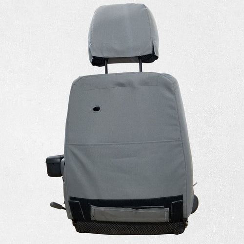 Back of CAT wheel loader seat with gray TigerTough seat cover installed
