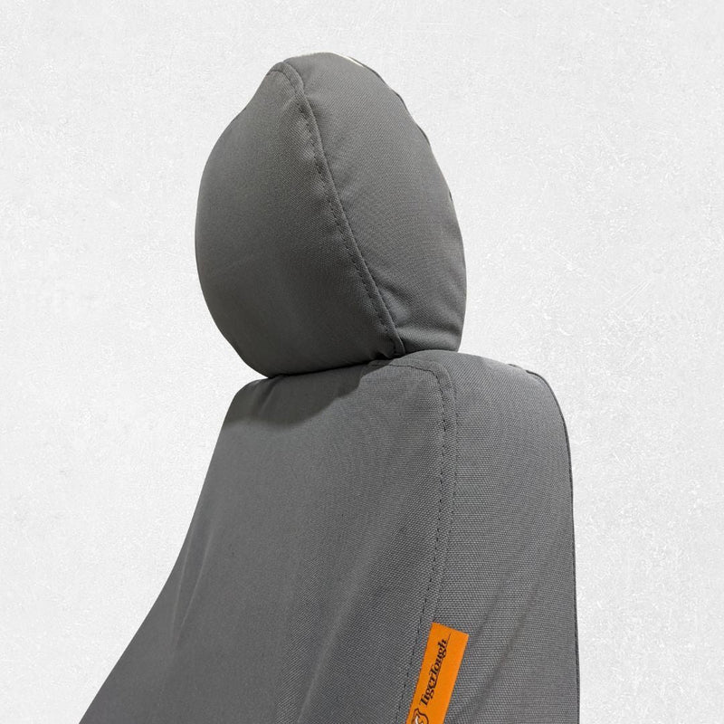 Komatsu excavator seat with gray TigerTough seat cover, headrest detail