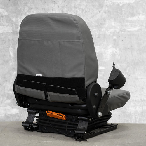 The back view of a heavy equipment seat with TigerTough seat covers on it. This picture shows the StringLock securing the strings behind the seat so you don't have to tie them, and it shows the sturdy hook-and-loop that secures the cover at the back.