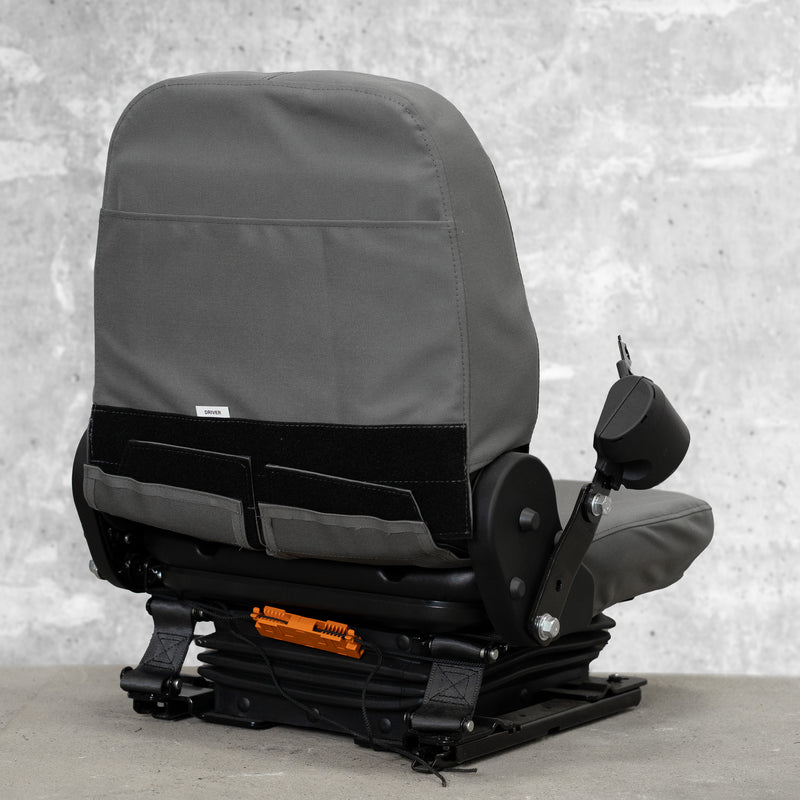 The back view of a heavy equipment seat with TigerTough seat covers on it. This picture shows the StringLock securing the strings behind the seat so you don't have to tie them, and it shows the sturdy hook-and-loop that secures the cover at the back.