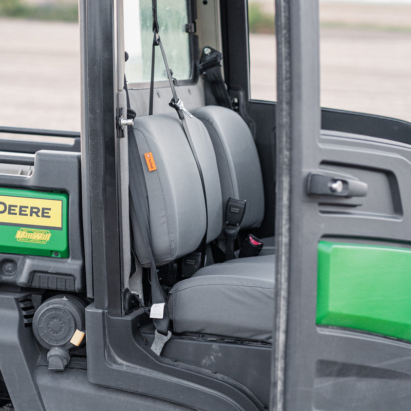 A picture of TigerTough seat covers protecting the seats in a John Deere Gator side-by-side. 