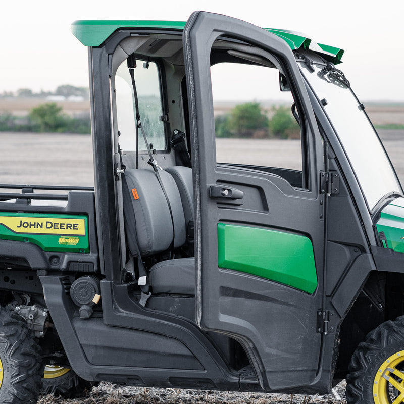 A John Deere Gator side-by-side with seats protected with TigerTough seat covers specifically made for this side-by-side