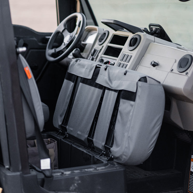 The bottom of the TigerTough seat cover on a John Deere Gator side-by-side. When the seat is flipped up, the seat cover stays secure.