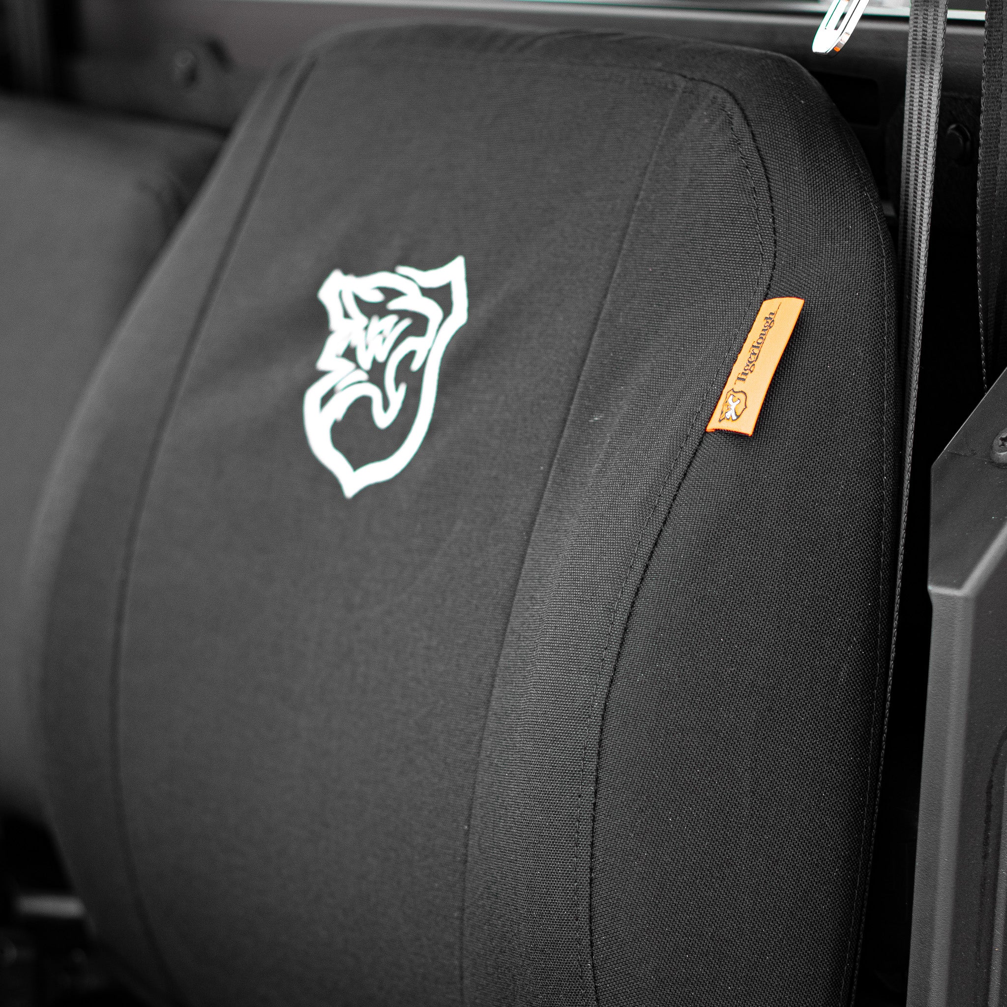 This picture shows a the TigerTough tag and the side seam on the edge of the TigerTough cover. Every set of seat covers is made in America from start to finish.