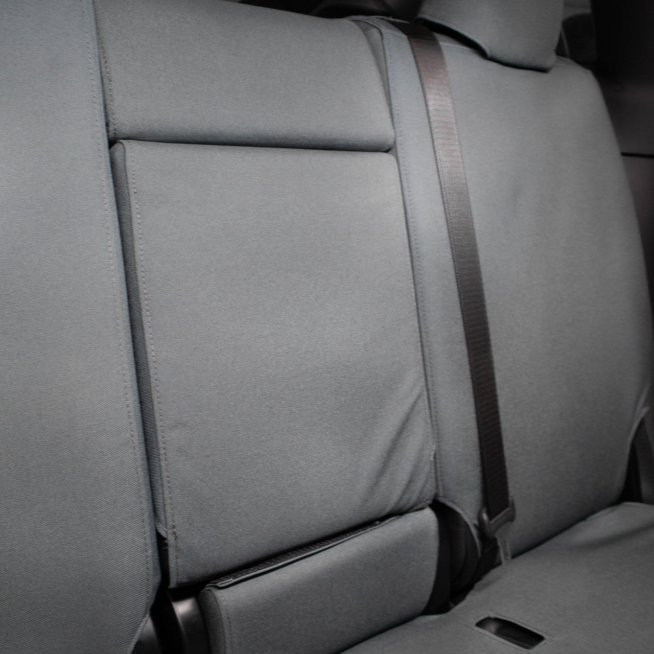 TigerTough Tactical Seat Covers on the rear seat of a Tesla Model Y - Folding Armrest Detail