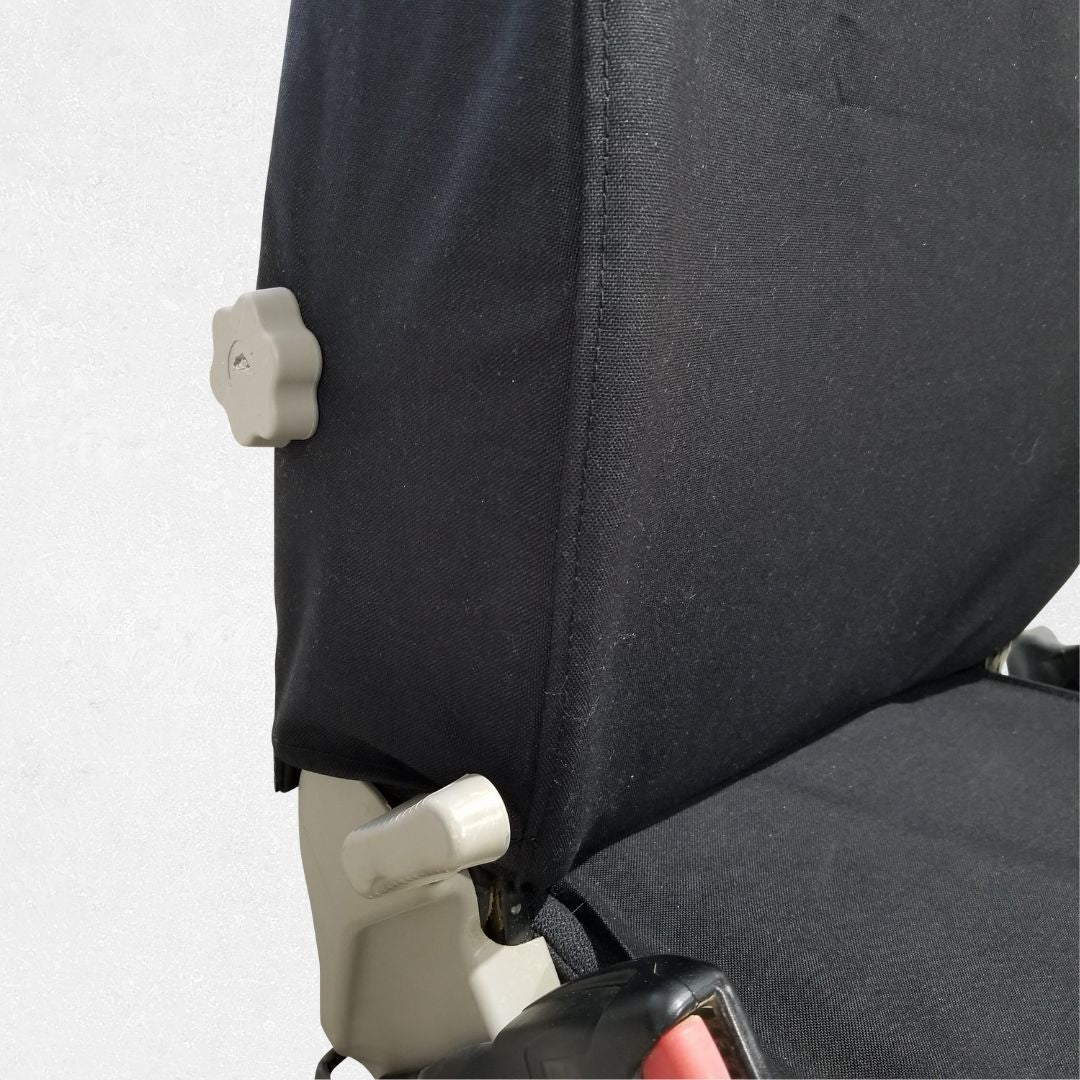 detail view of Komatsu excavator seat with black TigerTough seat cover