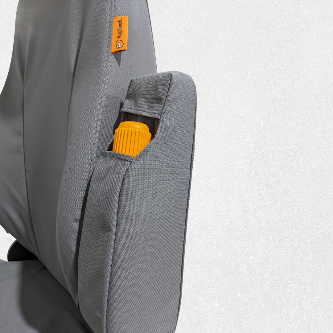 Komatsu wheel loader seat with gray TigerTough seat cover, armrest detail