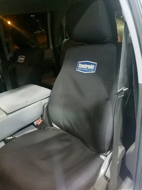 Ford Super Duty bucket seats with black TigerTough seat covers.