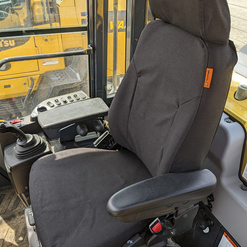 Komatsu wheel loader with black TigerTough seat cover.  Made in the USA.